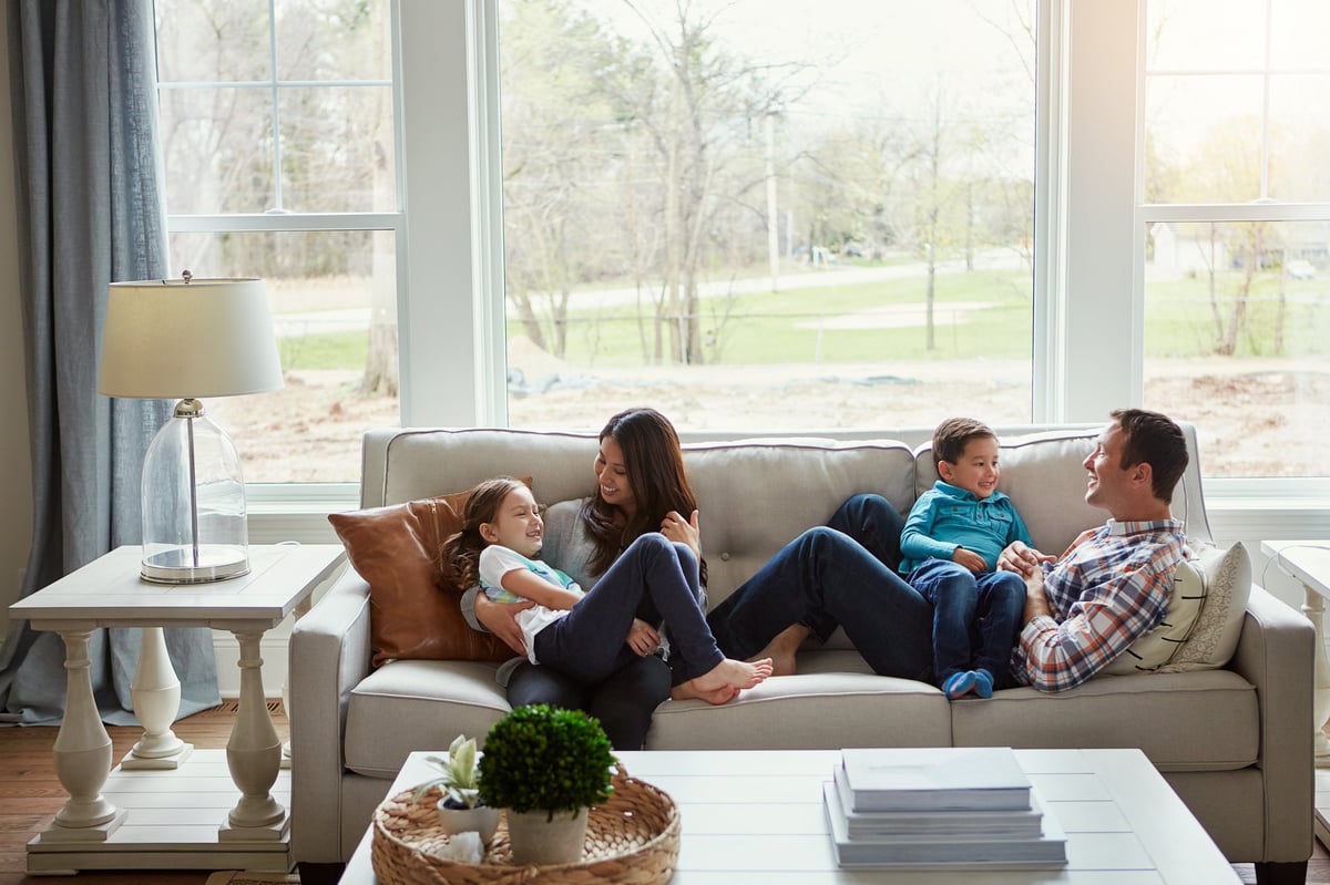 A loving family relaxing together on a comfortable sofa at home