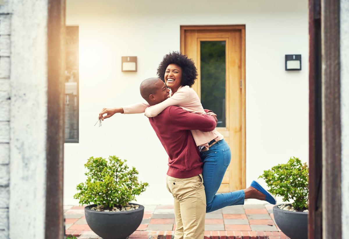 A happy couple celebrating the move into their new home